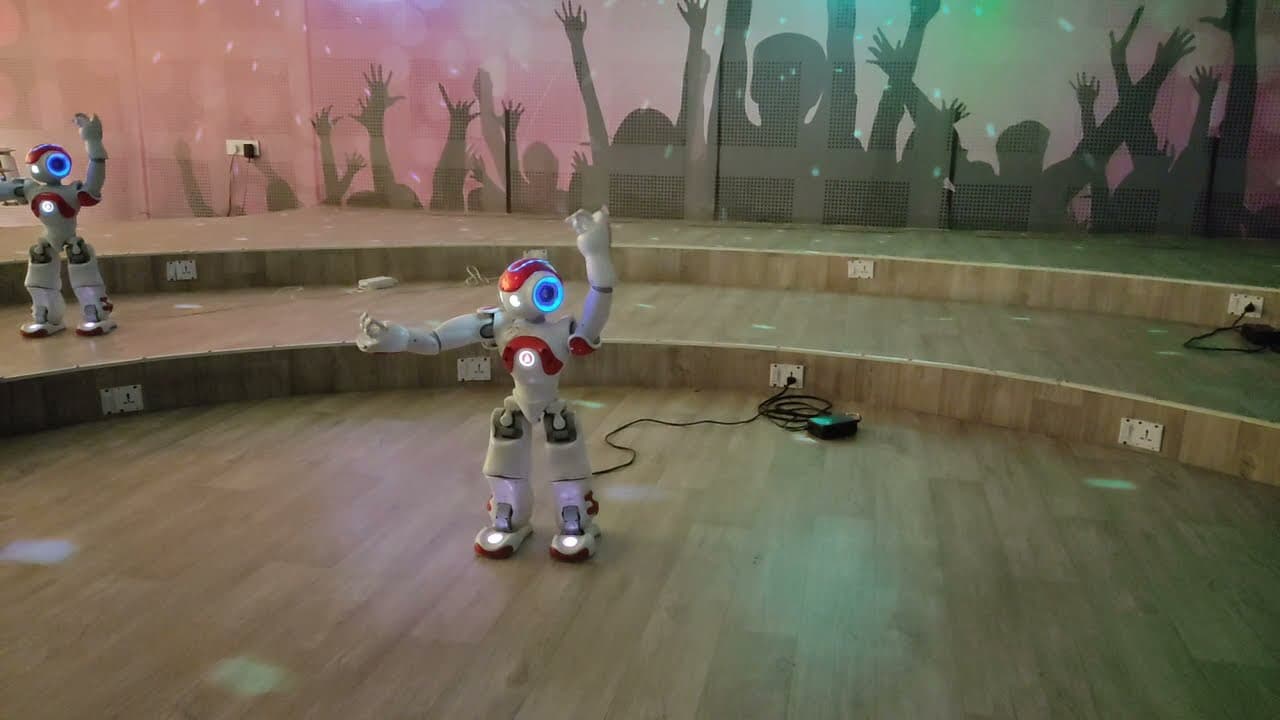 A group of humanoid robots musicians performs under colored lights at a robotic gallery in Gujarat Science City in India.